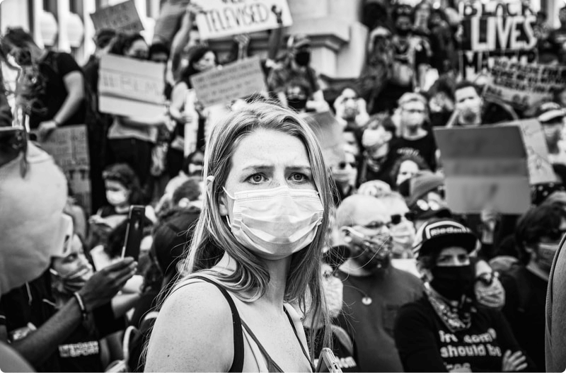 girl wearing a mask in a crowd